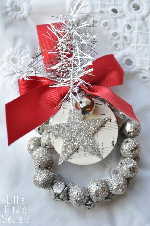 a silver glitter bell Christmas ornaments with a matching star, with a large red bow and bottle cleaner is a cool decor piece for Christmas