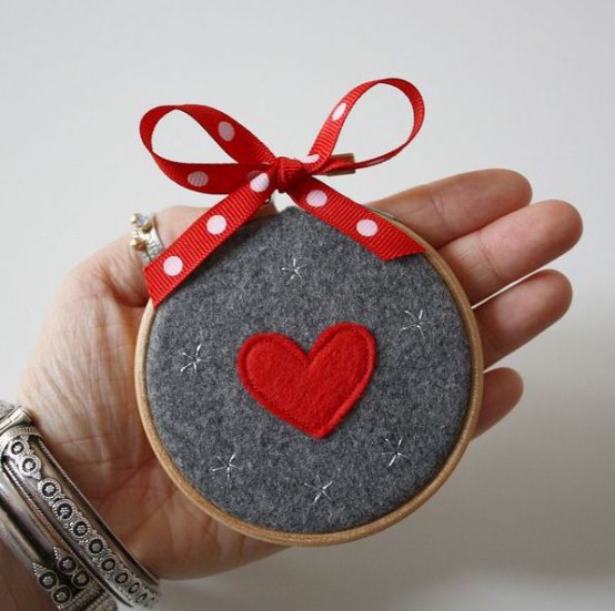 a grey felt Christmas ornament of an embroidery hoop, with a red heart and a red polka dot bow is a lovely and easy decoration