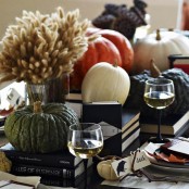 elegant rustic Halloween decor with natural pumpkins, wheat and bunny tails, books and wine is adorable