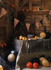 faux veggies and fruits, a burlap banner, candles in pumpkins for styling your space for Halloween with rustic touches