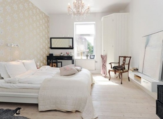 a welcoming Nordic bedroom with pritned wallpaper, a wooden floor, a white bed and a large storage unit