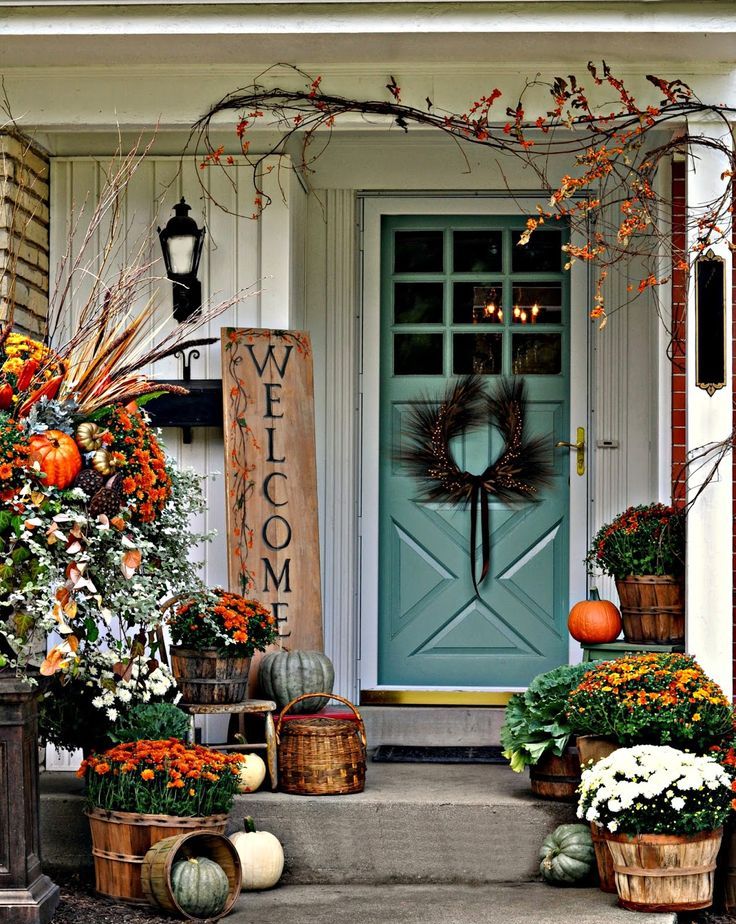 a sign, bold fall blooms in baskets, heirloom pumpkins, branches with berries and a lush floral and pumpkin arrangement