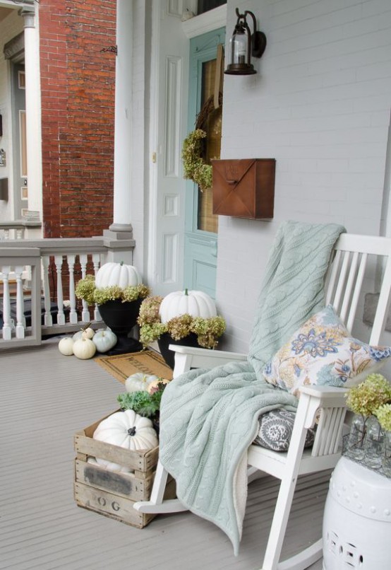 Cozy Thanksgiving Porch Decor Ideas Pumpkins mixed with faux moss could become a great addition to your porch if you put them in planters.