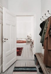 a chic Nordic space with white walls and doors and whitewashed floors to make the space softer and cozier