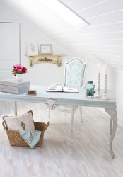a vintage attic home office with white walls and a ceiling plus a whitewashed floor and vintage furniture