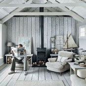 a neutral coastal living room with whitewashed walls, a ceiling, a floor and comfy furniture with a vintage feel