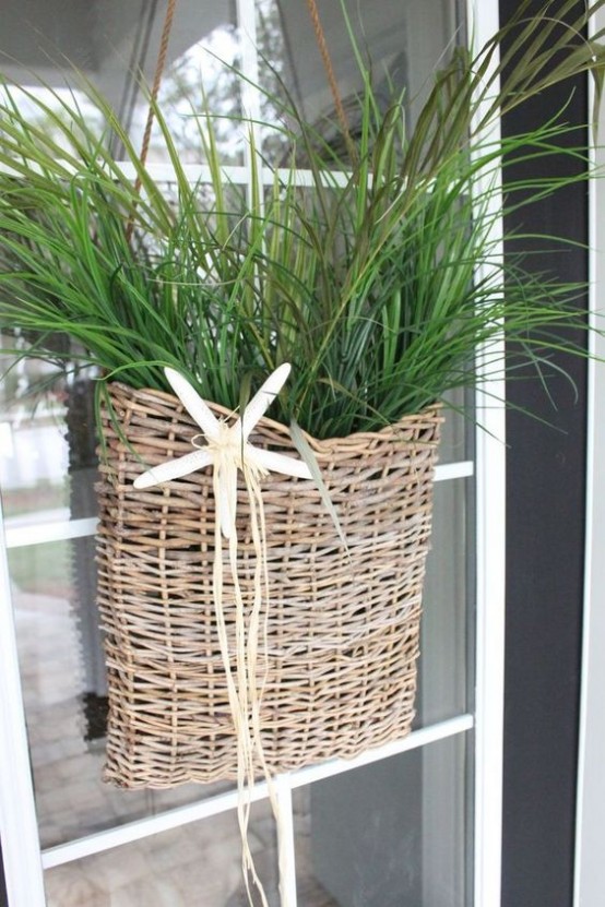 a wicker basket with greenery and a starfish is a lovely decoration for a beach or coastal space, use it instead of a usual wreath on your door