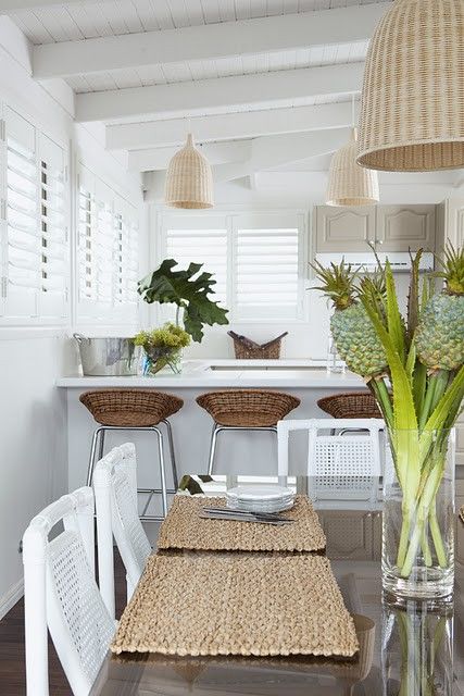 round wicker stools, neutral wicker pendant lamps and woven placemats for adding a rustic feel to the space