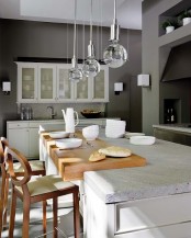 a white stone countertop paired with a sleek wooden part divide the cooking and meal zone easily