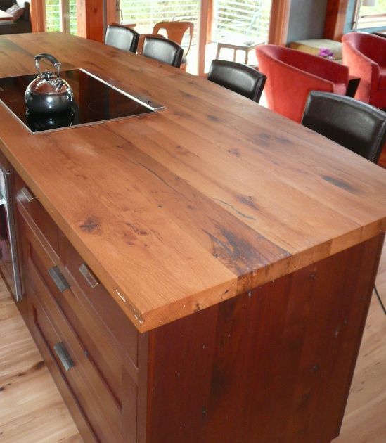 a dark stained kitchen with a rich stained wooden countertop is a cool idea to warm up the space and make it more welcoming