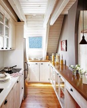 a white farmhouse kitchen enlivened with rich stained countertops looks inviting and very cozy