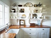a white farmhouse kitchen with rich stained butcherblock countertops is a stylish space with a bold look