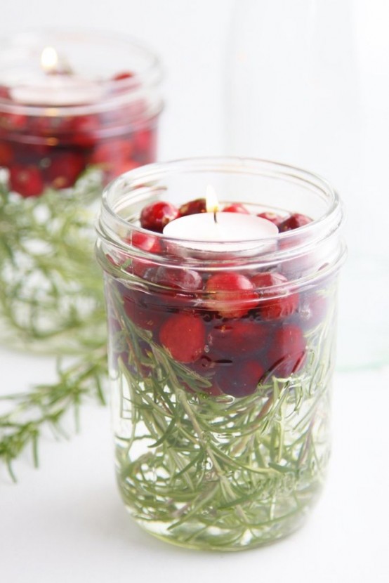 make a cool and lovely Christmas centerpiece of jars, greenery, cranberries and floating candles, they are awesome