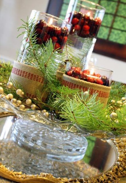 glass wrapped in burlap, with cranberries and evergreens plus floating candles are a cool Christmassy centerpiece