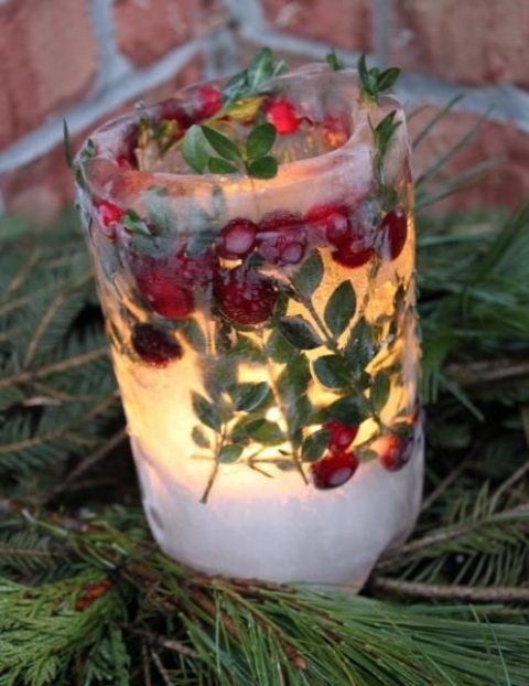 an ice candle lantern with greenery and cranberries is a lovely outdoor decor idea to rock, make some yourself