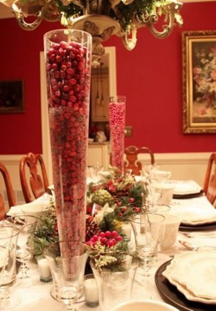 tall cone-shaped glasses filled with cranberries will instantly give your festive table a Christmassy look and feel, whatever decor they are paired with