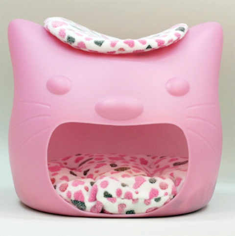 a pink cat head shaped bed or cat house with a colorful cushion inside and on top as two cat beds