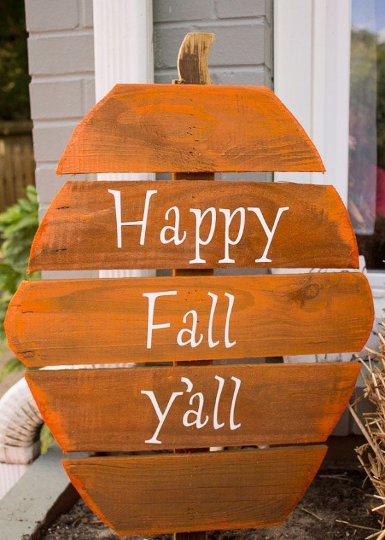 a rustic fall sign shaped as a pumpkin and painted orange plus white letters is a simple and cool craft