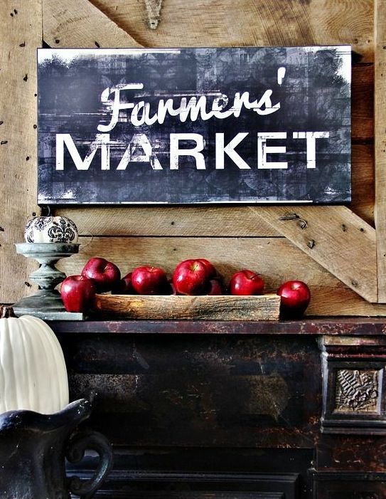 a large chalkboard sign and a wooden bowl with red apples under it is a cool idea with a farm feel