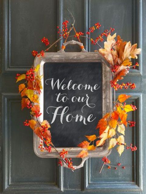 a chalkboard sign made of a tray and decorated with bold fall leaves looks amazing