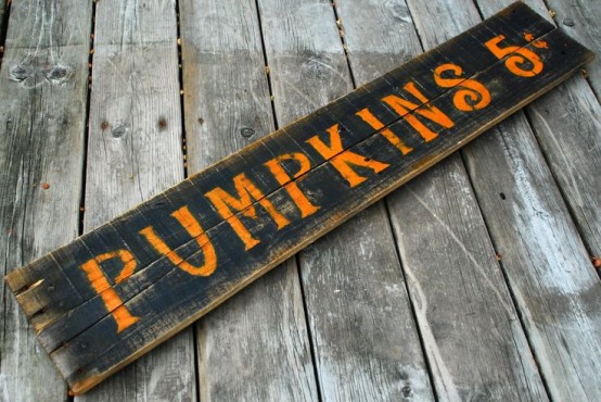 a black plank sign with orange letters is a fun and cool idea to accent your fall outdoor space