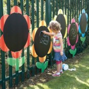 large chalkboard flowers attached to the fence look cool and fun and inspire your kids to be creative