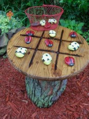 a small tic-tac-toe table with colorful stones is absolutely DIYable and you can make all its parts yourself