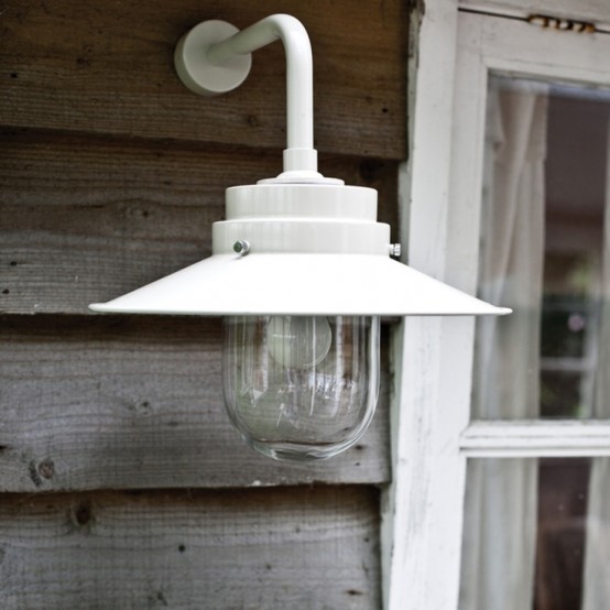 a simple white metal sconce with a vintage look attached to a wall of your house or terrace can be a nice solution that doesn't take floor space