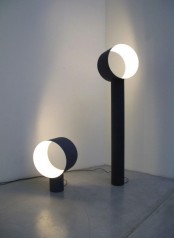 creative modern black and white lamps with a tube of light and different height will be a great and fresh solution for a modern outdoor space