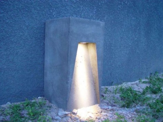 a concrete outdoor lamp looking very minimalist and giving just one ray of light is a statement idea that is very durable at the same time