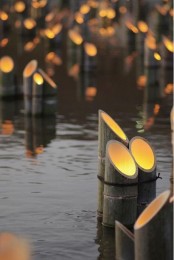 bamboo-shaped outdoor lamps used in packs are a great idea for a zen-like garden or just an outdoor space