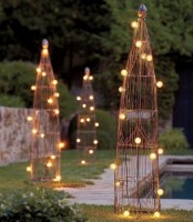 tall trellises with string lights are a simple and cool DIY solution for an outdoor space, whether it’s rustic or not