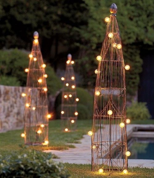 tall trellises with string lights are a simple and cool DIY solution for an outdoor space, whether it's rustic or not