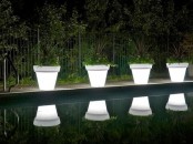 illuminated planters with greenery are amazing to line up a walkway or even a pool and they won’t take much space as they are double-duty pieces