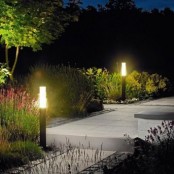 pole-shaped outdoor lamps like these ones don’t take ground space and will perfectly line up a walkway or a path, adding a modern feel to the garden