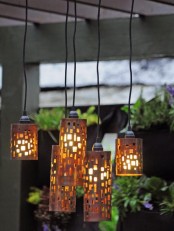 catchy pendant lamps with whimsical metal cutout lampshades will give subtle and intimate light to your outdoor space