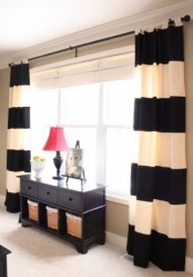 contrasting black and white horizontal stripe curtains will make your room look wider and larger