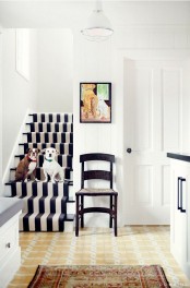 a black and white staircase with a black and white stripe rug is a lovely idea to accent this all-neutral light-filled space