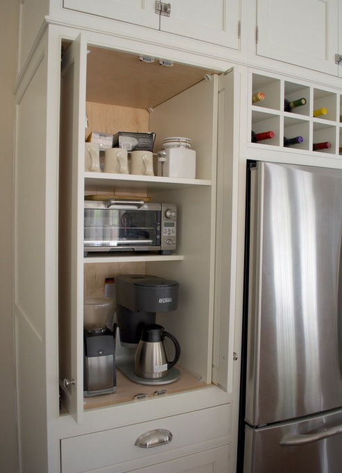 a neutral cabinet hides several appliances, sugar, tea and mugs is a lovely coffee or breakfast station