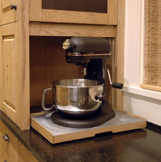 a small cabinet with a retracting shelf and a mixer is a pretty idea to hide your appliance and keep the kitchen neat