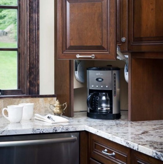 a dark stained cabinet with a sliding door and a coffee machine there is a lovely idea to hide everything you don't need right now