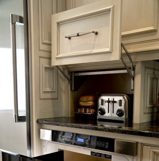 a cabinet with a moving door and a toaster hidden there is a lovely way to keep your kitchen neat