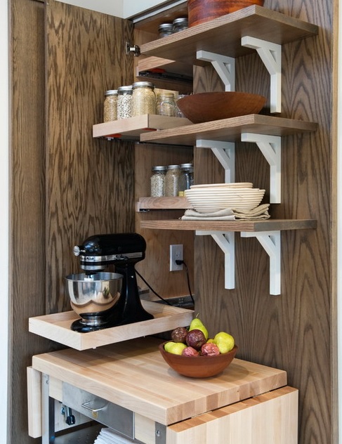 a narrow mini cabinet with a retractable shelf that hides a mixer and spices over it on matching shelves