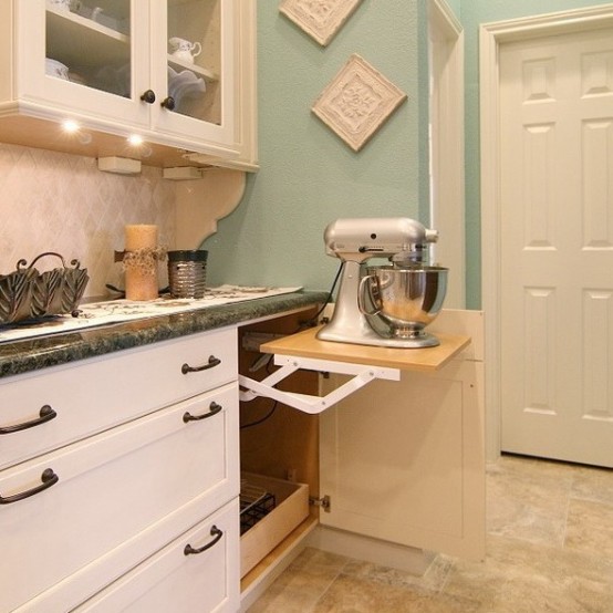 a cabinet with a retractable shelf and a mixer plus some cutlery under it is a cool idea for any kitchen