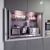 a sleek cabinet with glass and metal shelves inside, with appliances and some mugs and food inside will keep any space decluttered