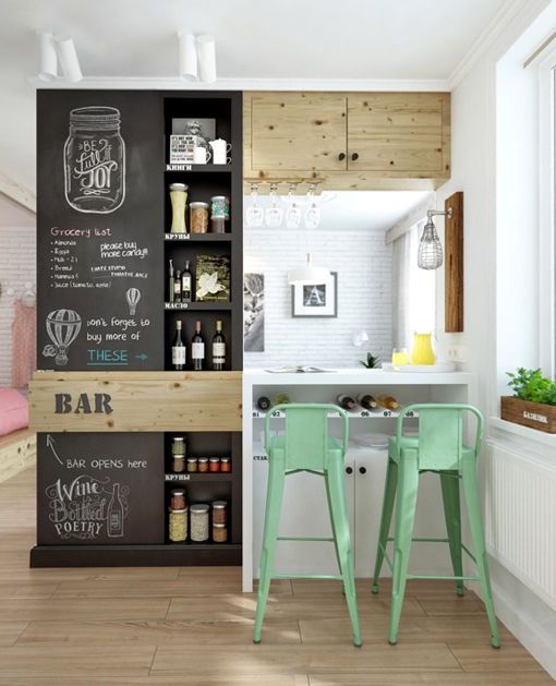 a farmhouse kitchen in white, a chalkboard cabinet for storing various stuff and make notes about this stuff plus green metal stools