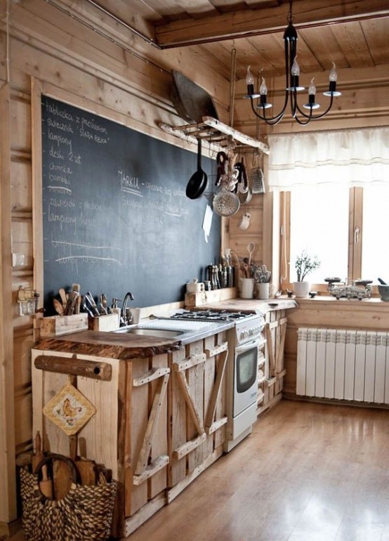 a rustic kitchen of wood, with catchy cabinets, a chalkboard in a frame that acts as a backsplash and as an art