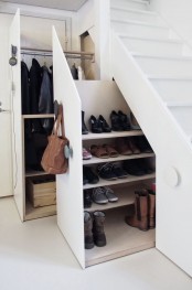 a whole closet and shoe storage hidden in the staircase drawers is a very functional idea that saves lots of space