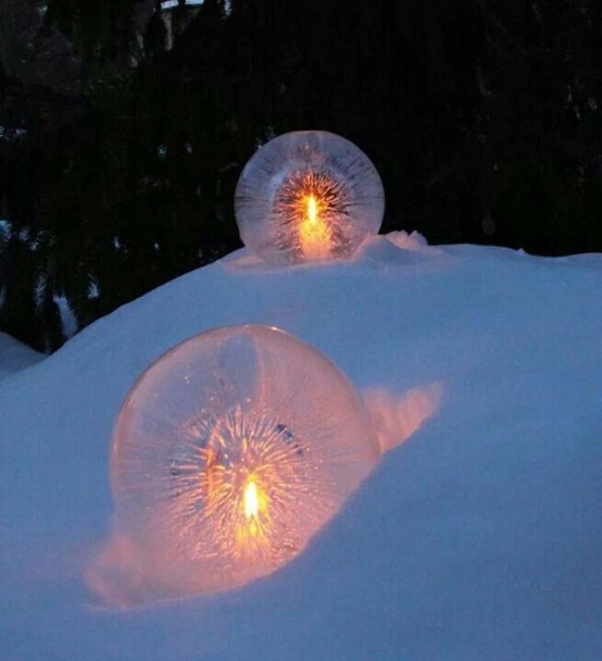 ice spheres with candles inside are amazing decorations for a snowy garden and they look magical