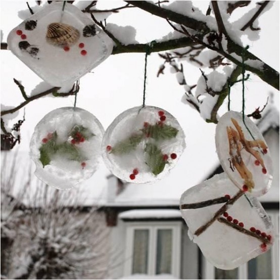 ice Christmas wreaths with berries, leaves, pinecones and seashells are a creative way to style your trees in the garden or even your fence